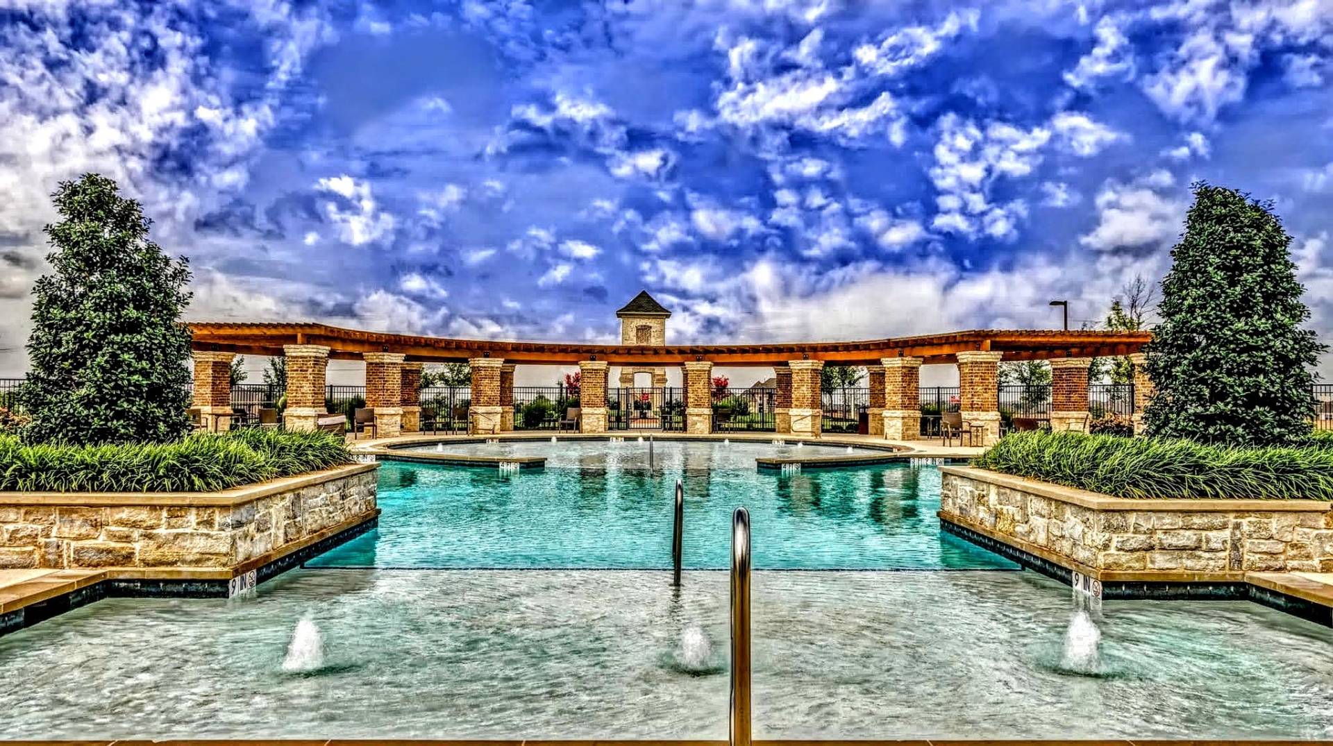 Swimming pool with fountains and landscaping in a residential community